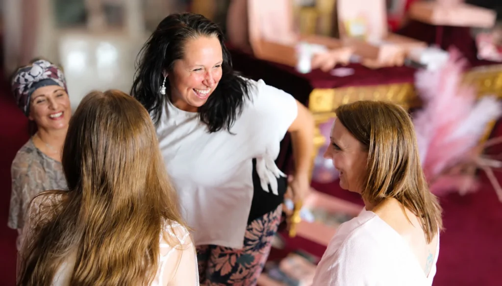 Smiling women chatting together at a community wellness gathering
