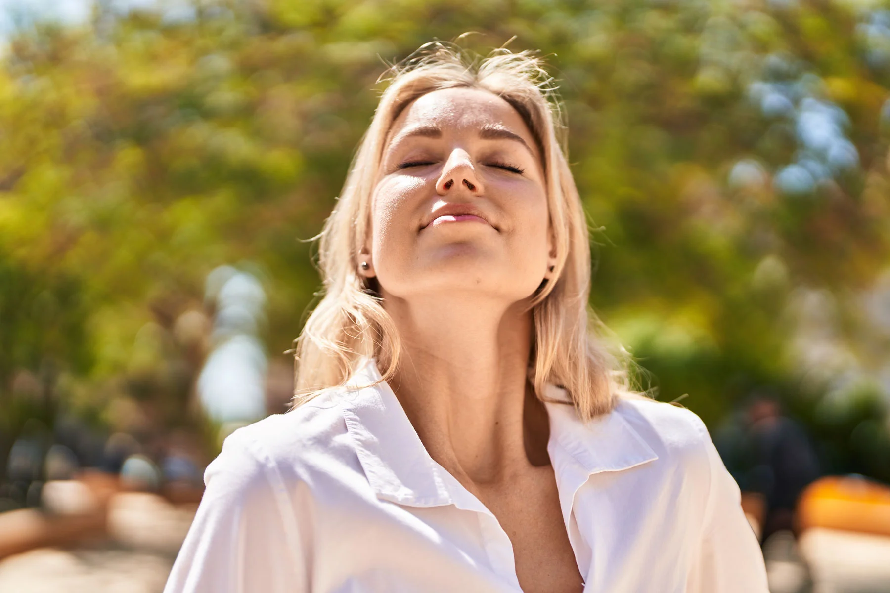 Woman breathing outdoors for pelvic health and body awareness